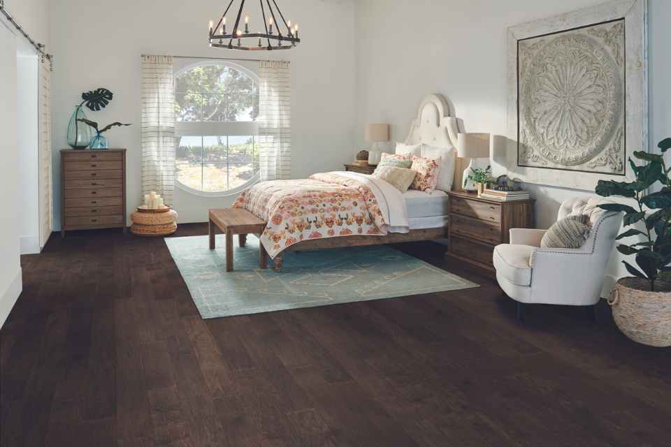 modern bedroom with dark hardwood and large marble wall art